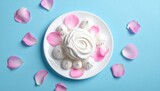 Elegant White Dessert with Pink Petals on a Blue Background, Artistic Food Photography.
