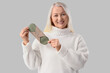 © Pixel-Shot - Mature woman with reusable menstrual pad on light background. Menopause concept
