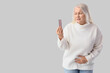 © Pixel-Shot - Mature woman with pills suffering from cramps on light background. Menopause concept