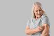 © Pixel-Shot - Mature woman applying contraceptive patch on light background. Menopause concept