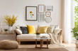 © Tohamina - Bright and airy living room with a cream sofa and yellow accents