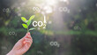 © TripleP Studio - CO2 or carbon concept with icons on green background. co2 emission using clean energy and limit global warming. renewable energy, planting tree. world earth day.