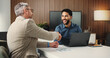 © OnPoint/peopleimages.com - Handshake, laptop and meeting with business people in office for congratulations, investor deal and partnership. Stakeholder approval, agreement and success with men shaking hands with tech and offer