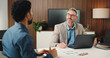 © OnPoint/peopleimages.com - Discussion, laptop and business men in office with graphs for stock market with finance report. Meeting, computer and male financial analyst with investor for investment proposal in workplace.