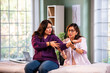© StockImageFactory - Senior female physiotherapist assessing elbow joint pain of young patient in clinic