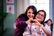 © StockImageFactory - Closeup portrait of Indian senior woman doctor with young beautiful patient smiling