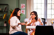 © StockImageFactory - Senior woman doctor measuring blood sugar of young female patient with glucometer