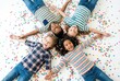 © Evgenia - Group of four children lying on colorful confetti-covered floor, smiling and enjoying playful moments, celebrating friendship and joy in a vibrant atmosphere