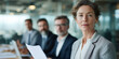 © Amazight - A confident woman leading a meeting in a modern office, exuding leadership and professionalism