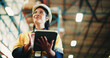 © peopleimages.com - Woman, tablet and warehouse inspection with smile, checklist or notes for inventory management. Person, tech and low angle with application, stock and thinking for supply chain at distribution plant