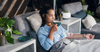 © peopleimages.com - Woman, relax and tea with IV drip for vitamins, nutrition or immune booster on bed in clinic. Female person, patient or drinking with herbal beverage or blood infusion for antioxidant or wellness