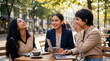 © redtiger9 - Amused ladies bonding over laptop and coffee at sunlit metropolitan terrace