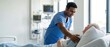 © Fernando - Indian male nurse caring for senior patient in hospital room Doctor comforting elderly man Healthcare, medical, and compassion