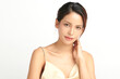 © kitthanes  - A beautiful young Asian woman with clean, fresh skin against a white background. Skincare, facial treatment, cosmetology, beauty, and spa. An elegant portrait of an Asian woman.