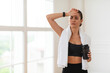 © Prostock-studio - Exhausted young woman wiping sweat from her forehead, feeling tired after training at home or gym, free copy space. Overworked female taking break from exercising, catching breath holding shaker