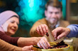 © .shock - Muslim family enjoys iftar together during Ramadan at a restaurant with festive decorations