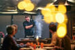 © .shock - Professional Restaurant Chef Cooking Meat with Flambe Technique at Table for Guests