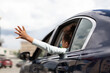© Prostock-studio - African American Kid Girl Putting Arm Out Of The Car Window Having Fun While Riding With Family In City. Summer Road Trip Adventure Concept. Back View, Selective Focus
