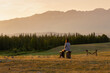 © Pavel - Back view of a female tourist sitting and enjoying nature panorama
