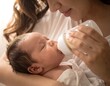 © Bubur - Mother gently feeds a newborn baby with a bottle of milk, nurturing and bonding