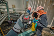 © chitsanupong - Worker hand holding gas detector inspection safety gas testing at front manhole