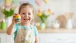 © dreamdes - Little girl with painted face holding a colorful Easter egg. Child happy creative art activity for Spring holiday fun