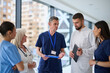 © .shock - Healthcare professionals discuss patient care strategies in a modern hospital setting during a morning shift