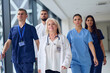 © .shock - Medical team walks confidently down a modern hospital corridor during a busy shift in the afternoon