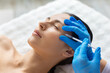© Anastasiya - Closeup of young beautiful woman undergoing professional aesthetic facial procedure with syringe, calm expression, clean clinic setting highlighting modern skincare and beauty treatment
