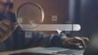 © The KonG - Hand holding a magnifying glass over a glowing search bar with AI, web, and data icons, representing artificial intelligence-powered search, digital innovation, and online discovery tools.
