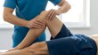 © Artfinity - Professional physical therapist examining a patient knee. Sports medicine and rehabilitation. Healthcare worker in blue scrubs performing manual therapy on an athlete leg
