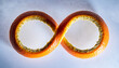 © Payou - Infinity Shape Pastry Duo On Blue Background.