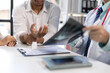 © Wasan - Doctor is diagnosing a patient's arm and wrist pain in an examination room. Doctor showing wrist x-ray to patient complaining about wrist pain.