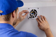 © ronstik - HVAC service worker working on bathroom ventilation exhaust fan