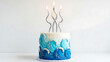 © simz - Beautiful blue wave cake with three lit candles on top