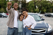 © Prostock-studio - New Car. Happy Black Family Showing Own Automobile Key To Camera Standing Near Auto Posing Outdoor. Vehicle Purchase And Rent, Dealership Advertisement Concept