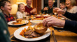 © Ain - A family enjoys a hearty Sunday roast dinner with all the trimmings at a warm, festive table