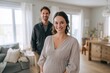 © Oleksandr - Shared joy at home: pregnant woman with her partner smiling in a comfortable domestic setting