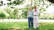 © Rawpixel.com - Elderly couple walking in a park, smiling and embracing. The elderly couple enjoys a sunny day, surrounded by trees, sharing a joyful moment outdoors. Happy elderly couple walking in the park.