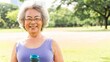 © Rawpixel.com - Senior woman outdoors, smiling in a park. She holds a water bottle, enjoying nature. Asian woman, gray hair, wearing glasses, embracing a healthy lifestyle. Senior Asian woman, wellness in park.