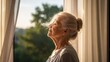 © Luiz  Fernando - Elderly woman standing near an open window in the early morning, soft wind moving her hair and curtains, warm sunlight touching her skin, peaceful expression