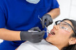 © Guillermo Spelucin - Dentist examining patient during routine dental check up