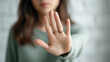 © mangolovemom - Woman hand gesture stop refusal female palm close up warning person protest sign boundary human finger ring jewelry focus blurred face background
