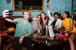 © oneinchpunch - Diverse friends taking selfie celebrating party with champagne