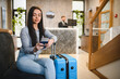 © Serhii - Woman checking travel documents at hotel lobby