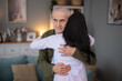 © Dexon Dee - Elderly man hugging female caregiver expressing comfort