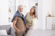 © New Africa - Lovely senior couple dancing together at home