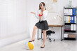 © New Africa - Woman with inflatable ball talking on phone in office. Space for text