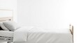 © FahVecStudio - A neatly made hospital bed with white linens and pillows, ready for a patient's rest in a clean, bright room