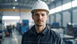© VINA - Industrial worker in protective gear stands facing camera with determined gaze inside manufacturing facility